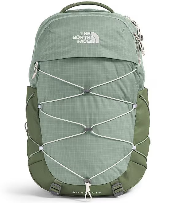 The North Face Borealis backpack in sage green and olive green, featuring a front zippered pocket with the brand logo and white compression straps.