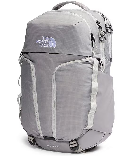 The North Face light gray backpack with multiple zippered compartments, side pockets, and a top carry handle, shown on a white background.