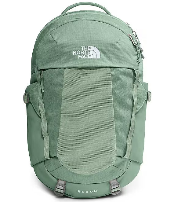 The North Face Reeton backpack in sage green, featuring a front mesh pocket, zippered side pockets, and a top carry handle on a white background.