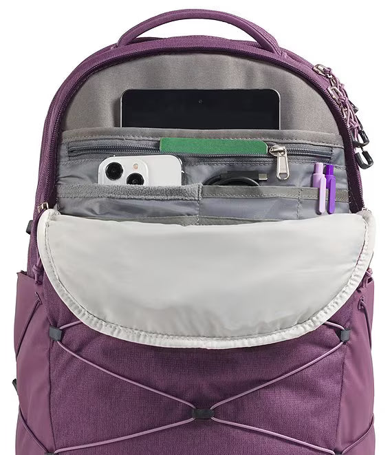 A purple backpack shown open to display its interior organization, including a laptop compartment, phone pocket, and pen slots, against a white background.