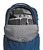 A blue and gray backpack shown from the front, with the top zipper open and a strap or accessory visible inside the compartment.