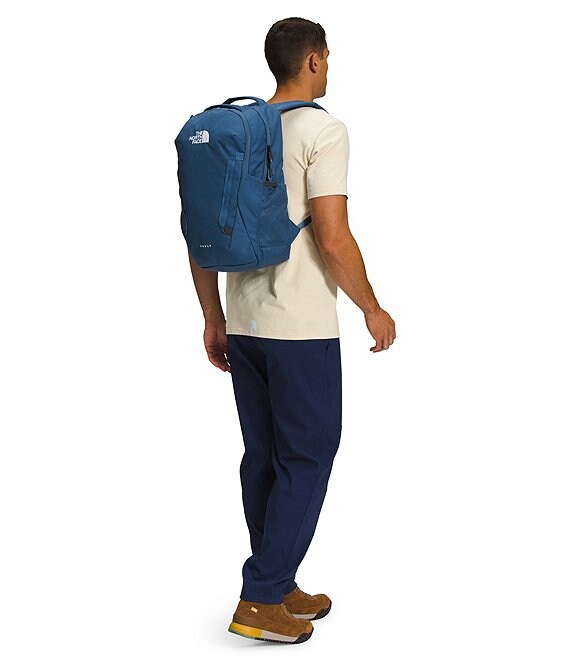 Person wearing a blue backpack on a white background