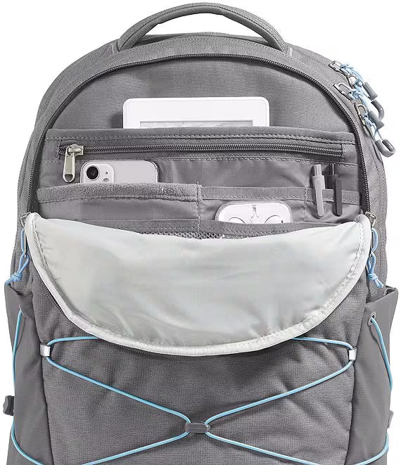 A gray backpack shown open, displaying its multiple zippered compartments and front pocket with light blue accent straps, photographed against a white background.