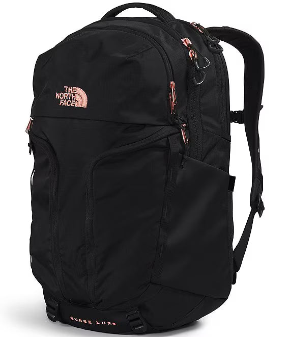 The North Face Surge Lush backpack in black with rose gold accents, including the brand logo and zipper pulls, shown on a white background.