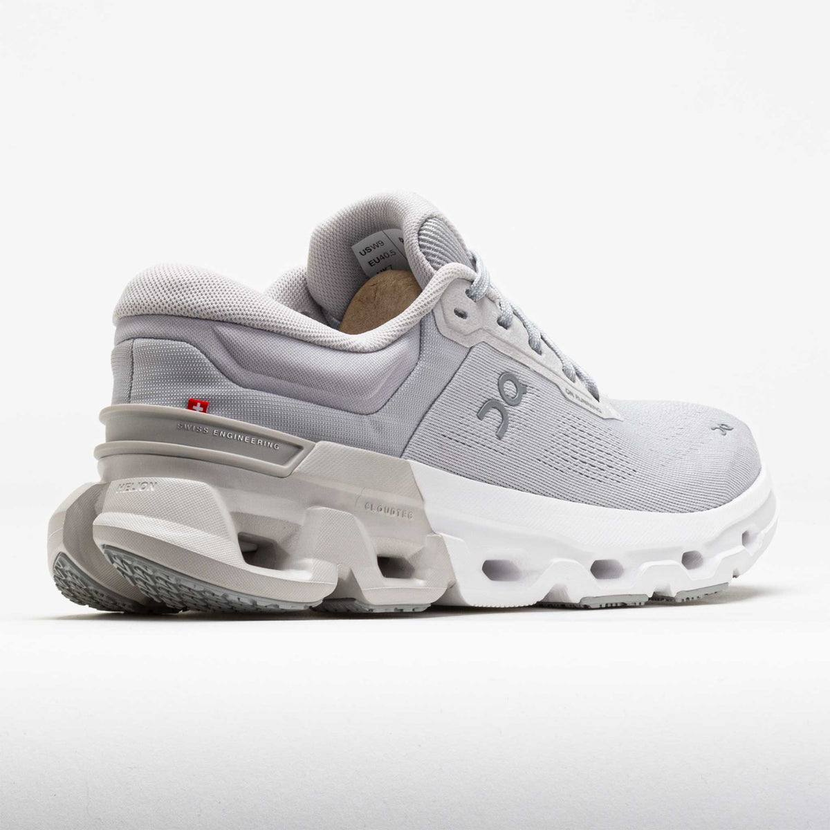 Gray athletic shoe with a white sole on a light gray background