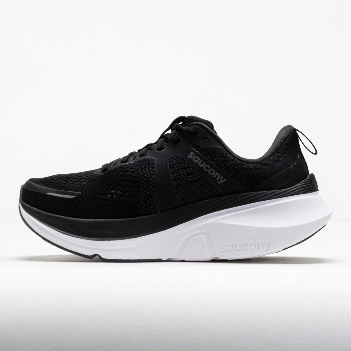 A black Saucony running shoe with a thick white midsole, shown in a side profile view against a light gray background.