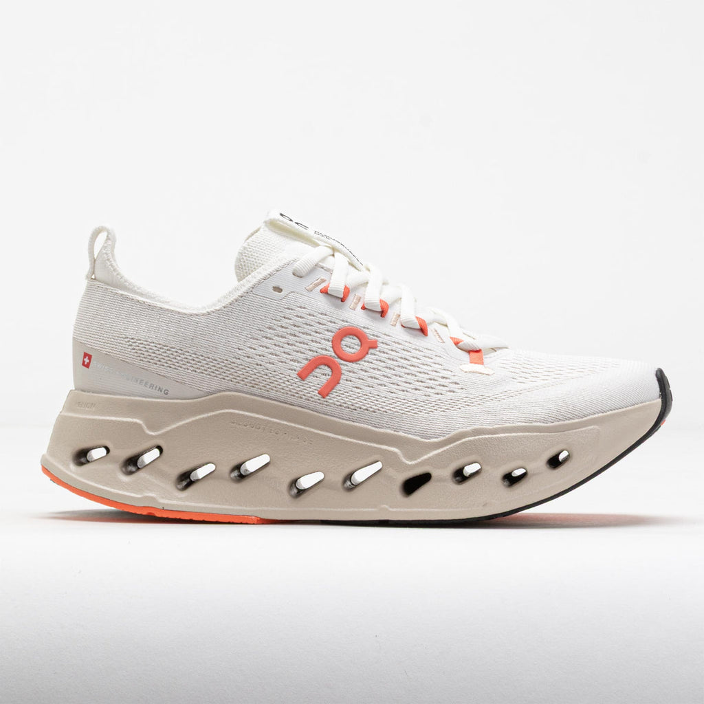 White running shoe with orange accents on a light gray background