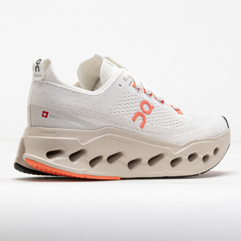 White and gray athletic shoe with orange accents on a white background