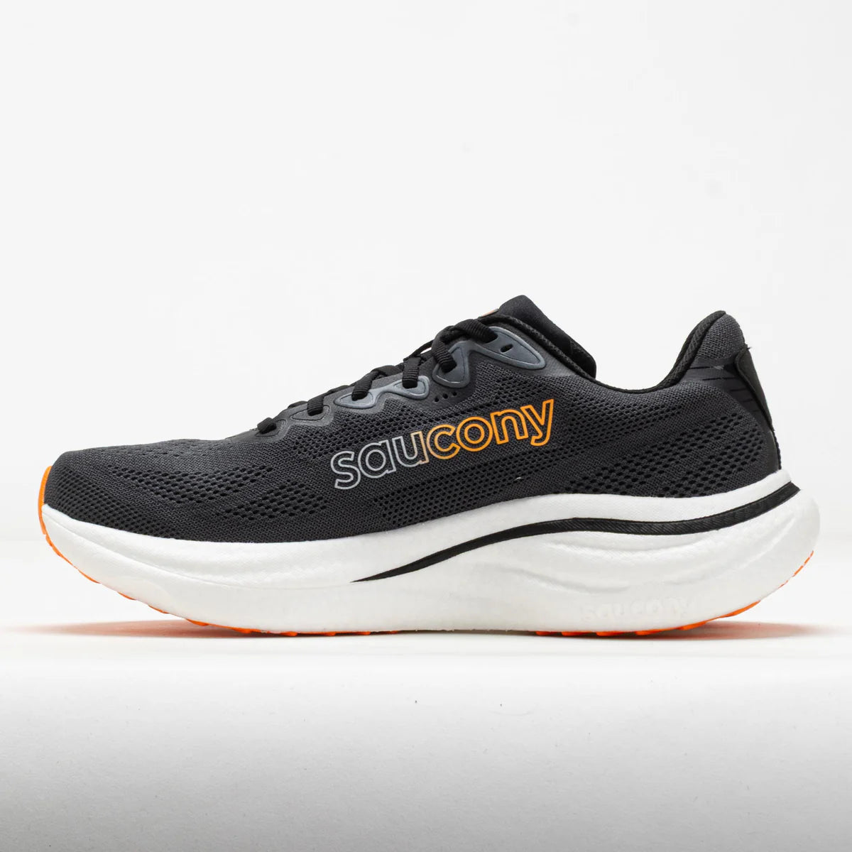 A Saucony athletic shoe in black mesh with a thick white midsole and orange accents, shown in a side profile on a light gray background.