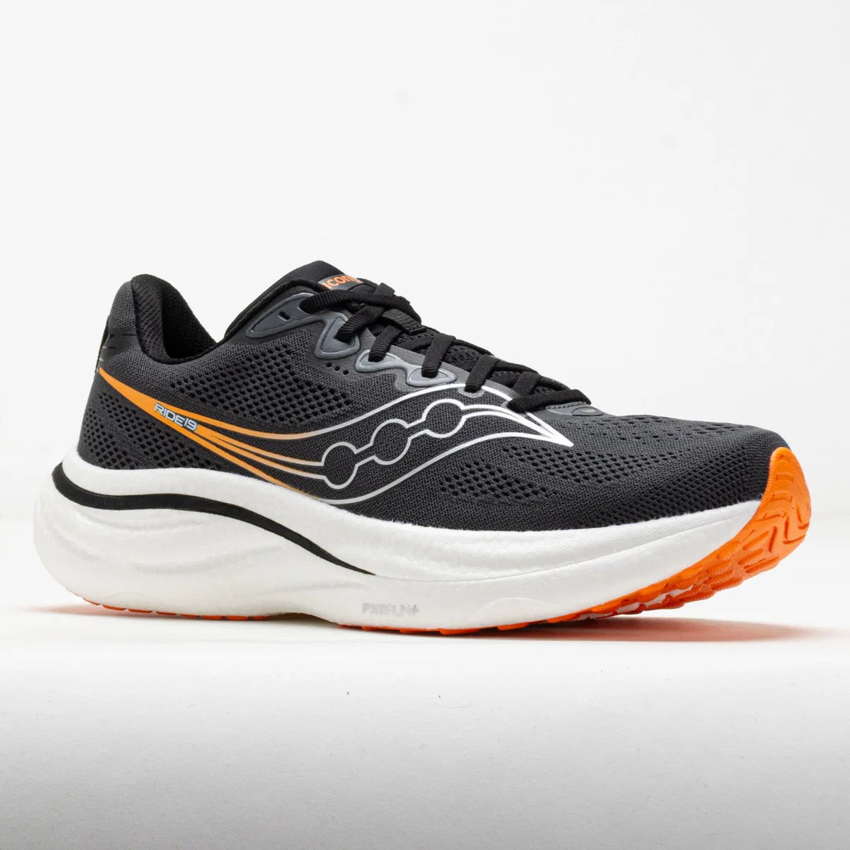 A Saucony running shoe in black mesh with a thick white midsole and bright orange accents on the side logo, toe cap, and outsole, shown against a plain white background.
