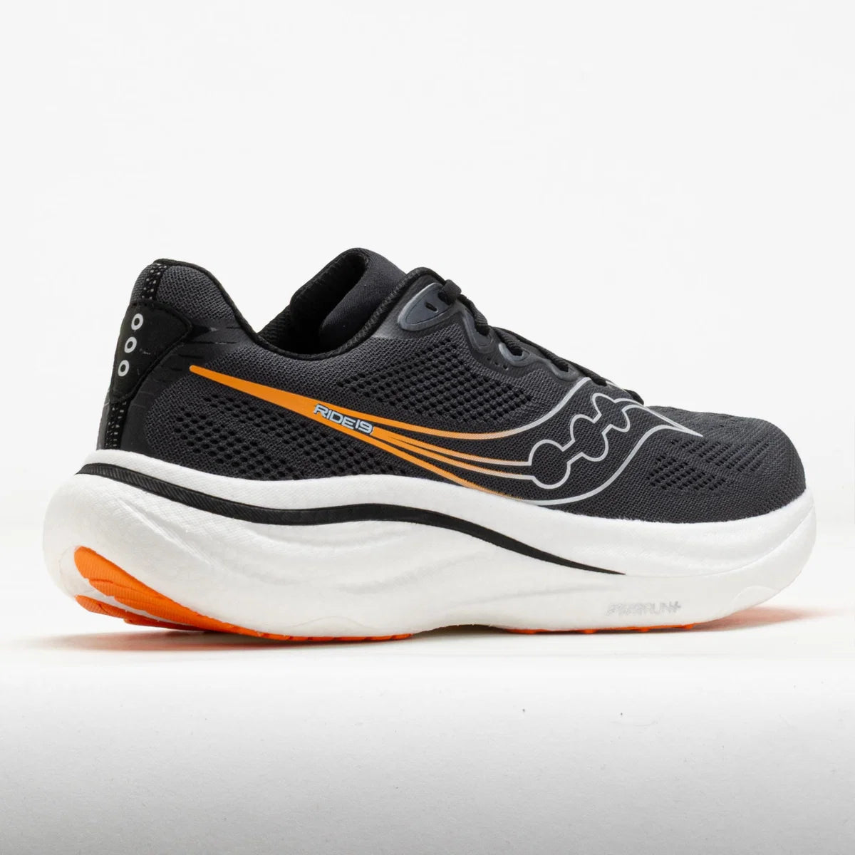 A Saucony running shoe in black mesh with a thick white midsole and bright orange accents on the side and outsole, shown against a plain white background.