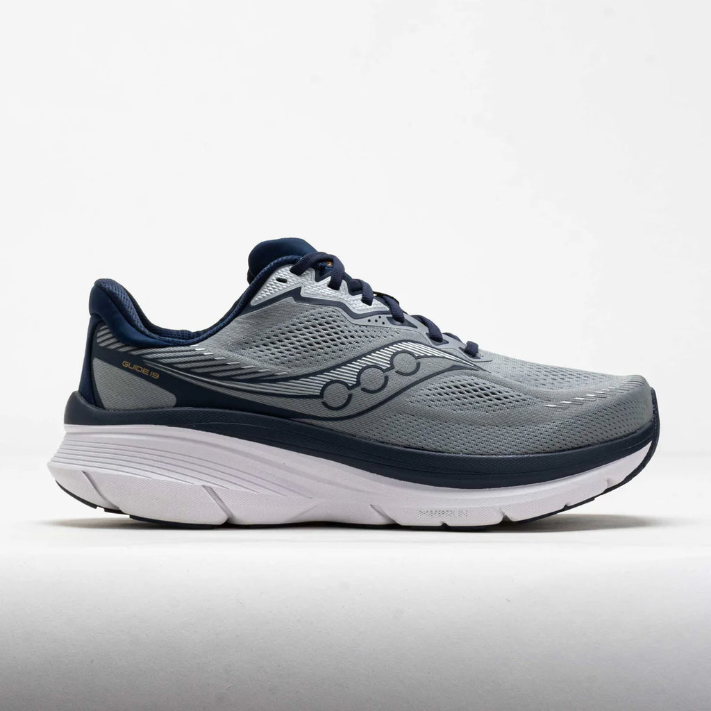 A Saucony running shoe in gray and navy blue, shown from a side profile view against a light gray background.