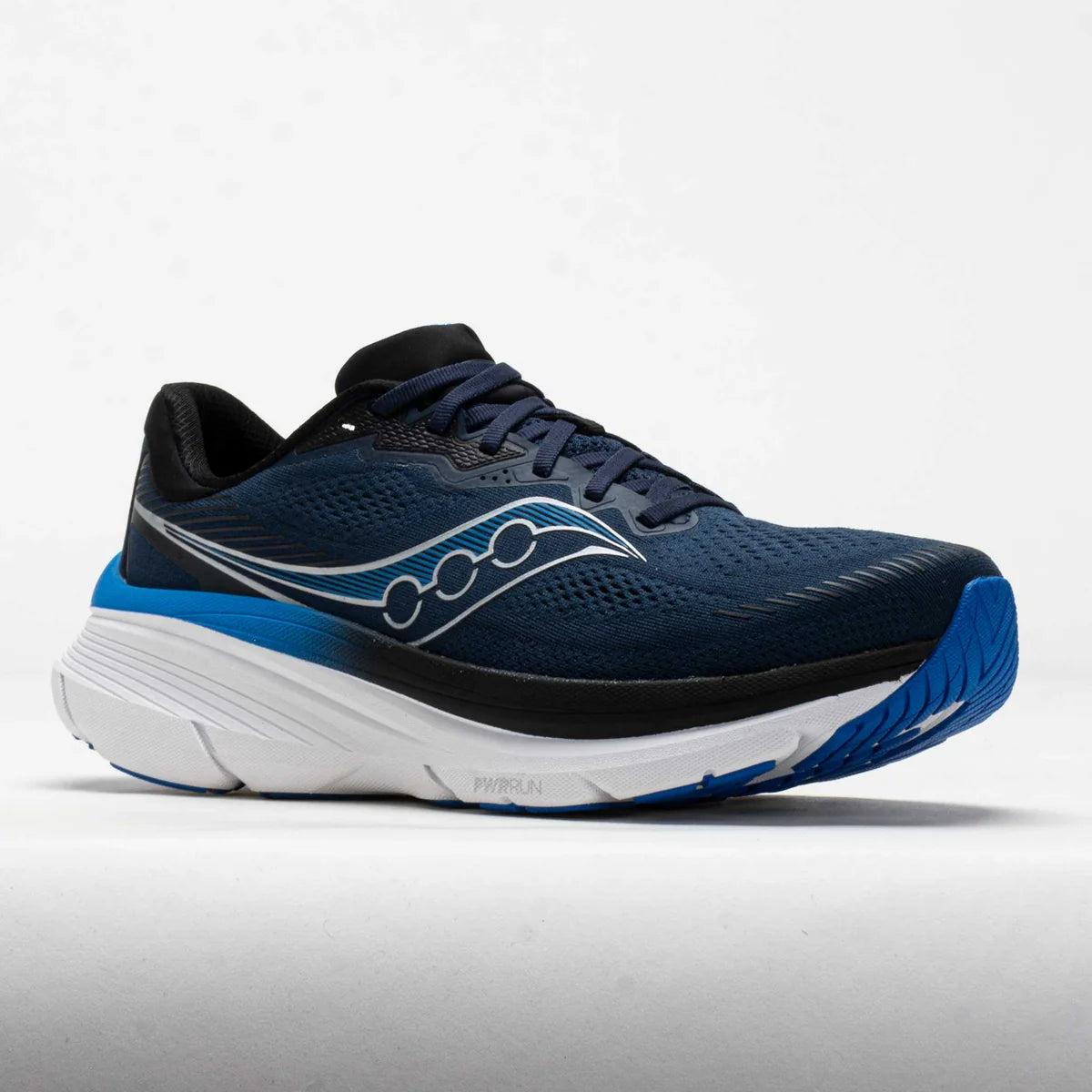A Saucony running shoe in navy blue with a white and blue midsole, featuring the Saucony logo on the side, photographed against a light gray studio background.
