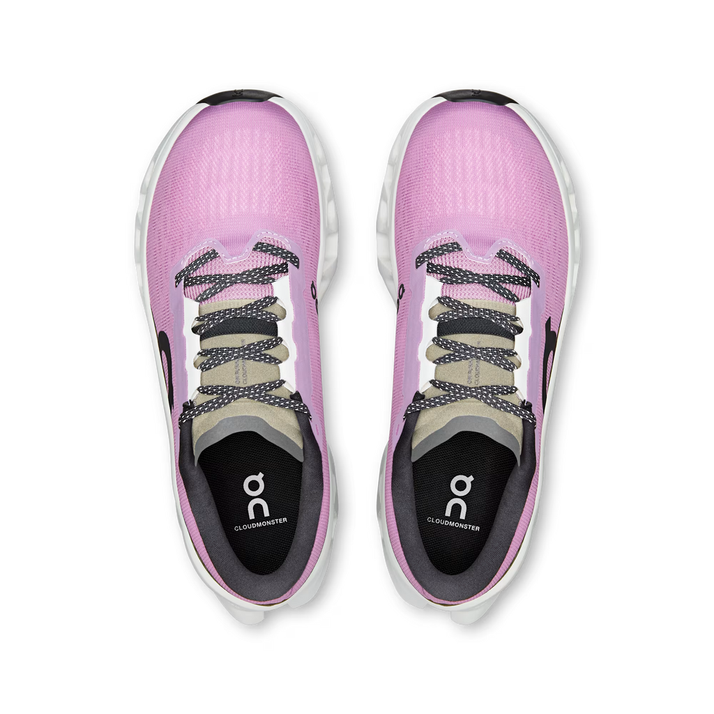 Pink athletic shoes with a visible brand logo on a white background