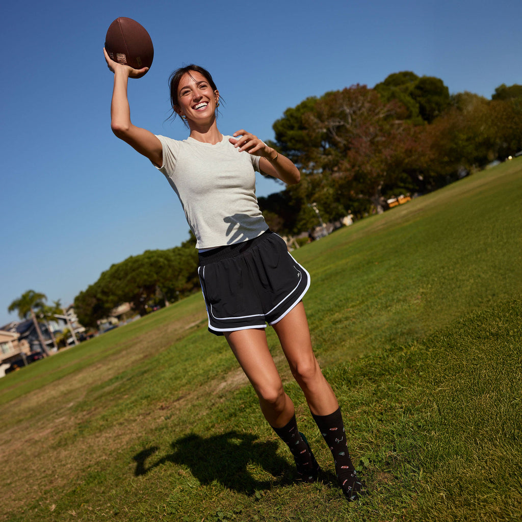 Socks that Support Youth Sports (Black Footballs)