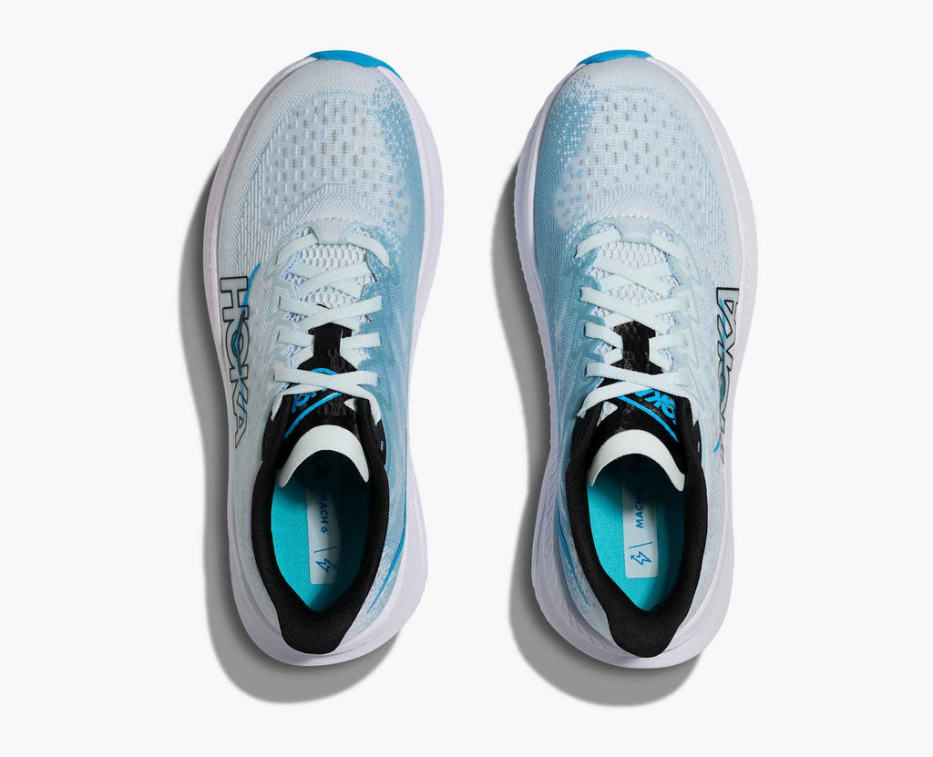Pair of white running shoes with blue accents on a white background