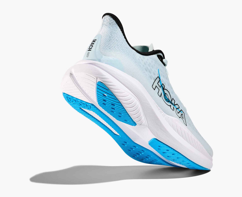 White running shoe with blue sole on a white background