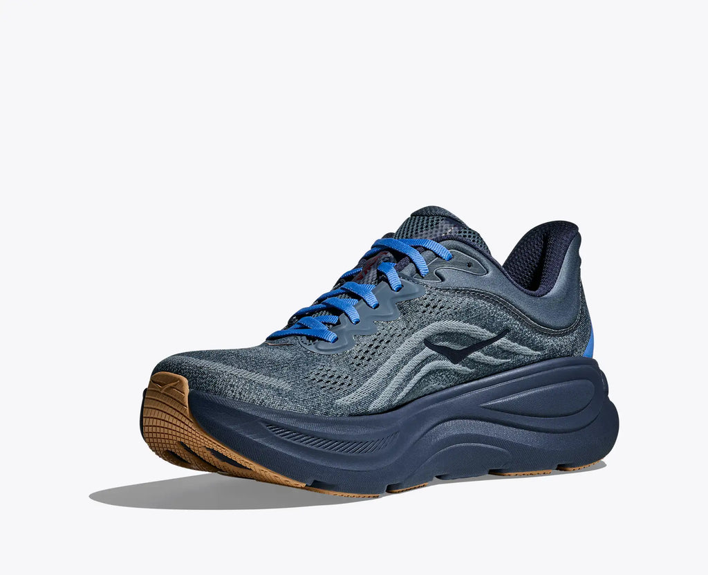 Blue running shoe with brown sole on a white background