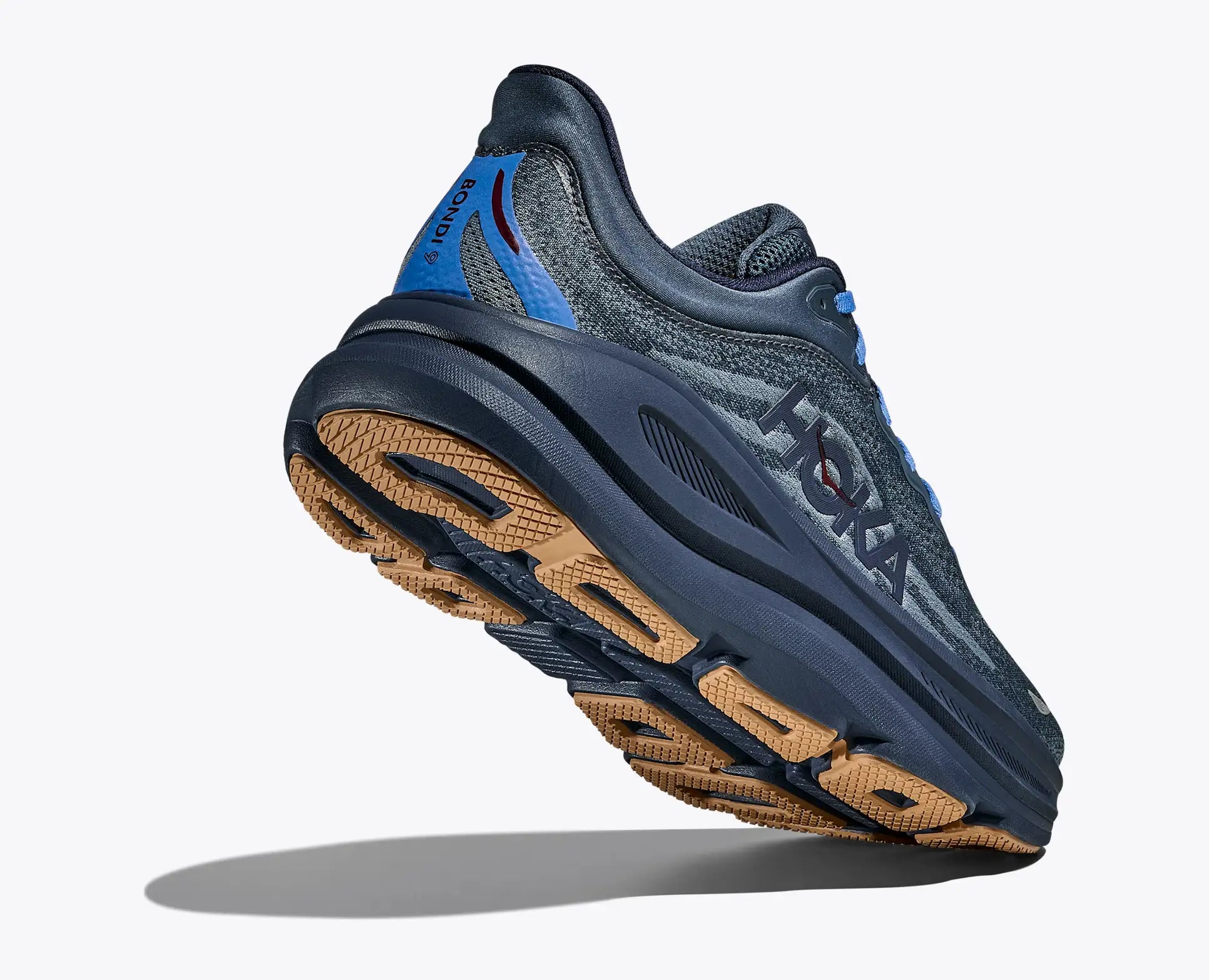 Blue running shoe with brown sole on a white background