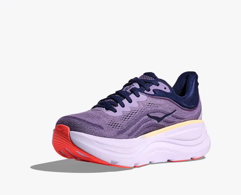 Purple running shoe with orange sole on a white background
