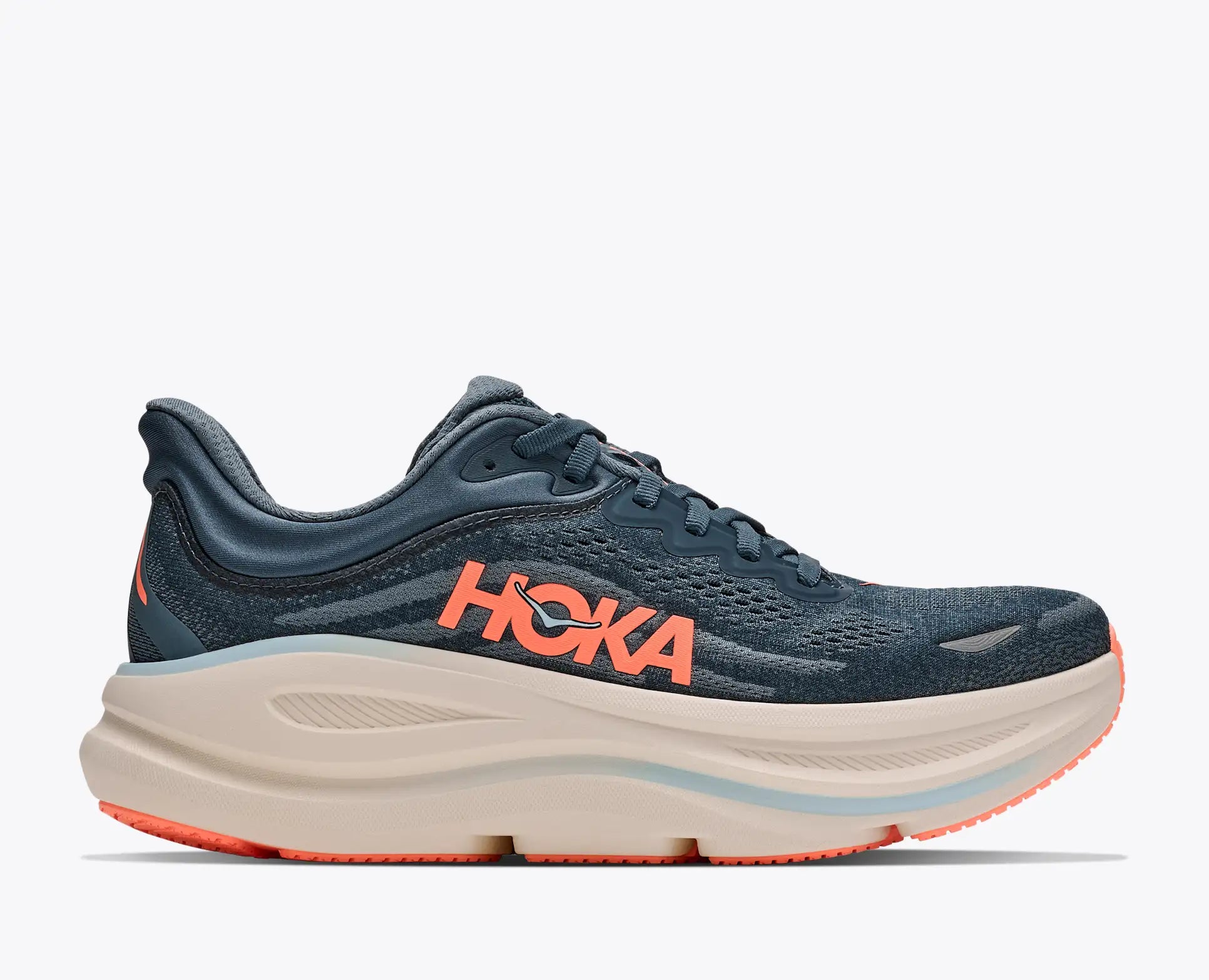 A Hoka running shoe in navy blue mesh with a thick beige midsole and bright orange accents, shown from a side profile view against a light gray background.