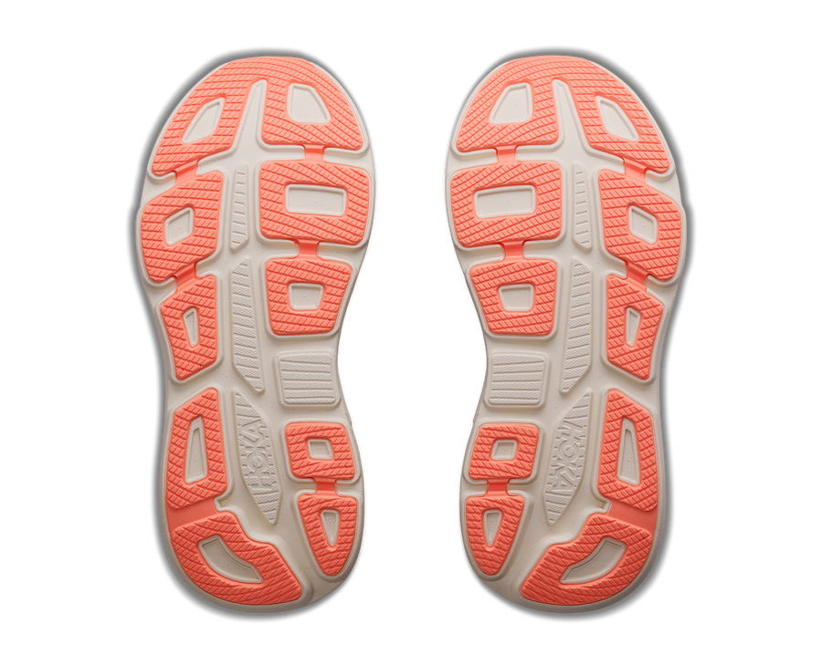 Close-up of a pair of running shoes with pink soles on a white background