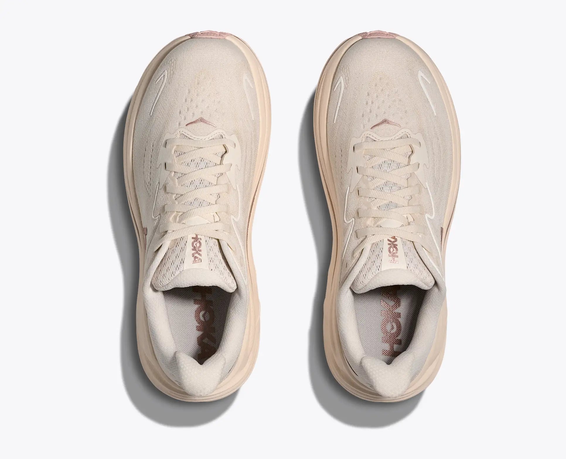 Pair of beige sneakers on a white background