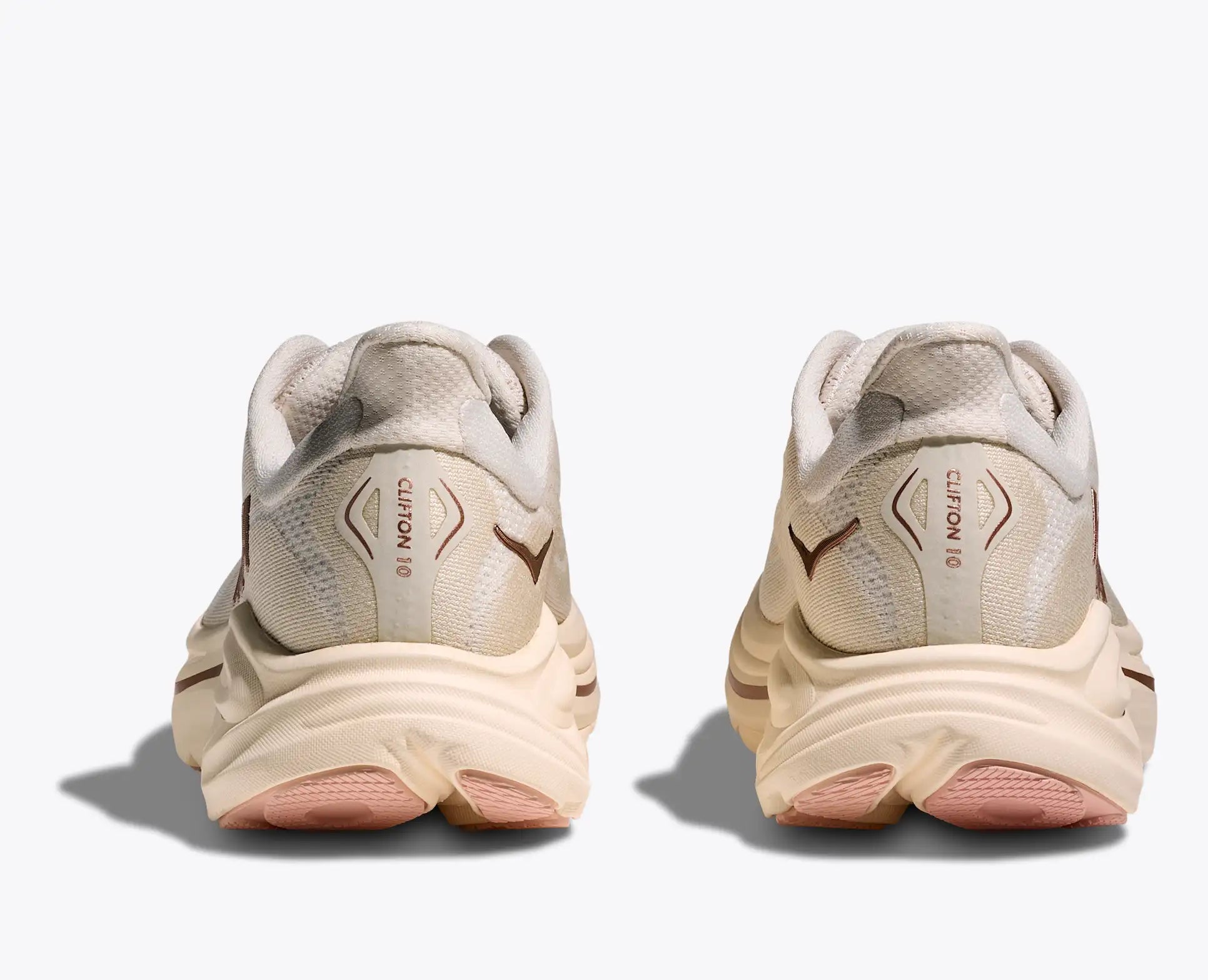 Pair of beige running shoes on a white background