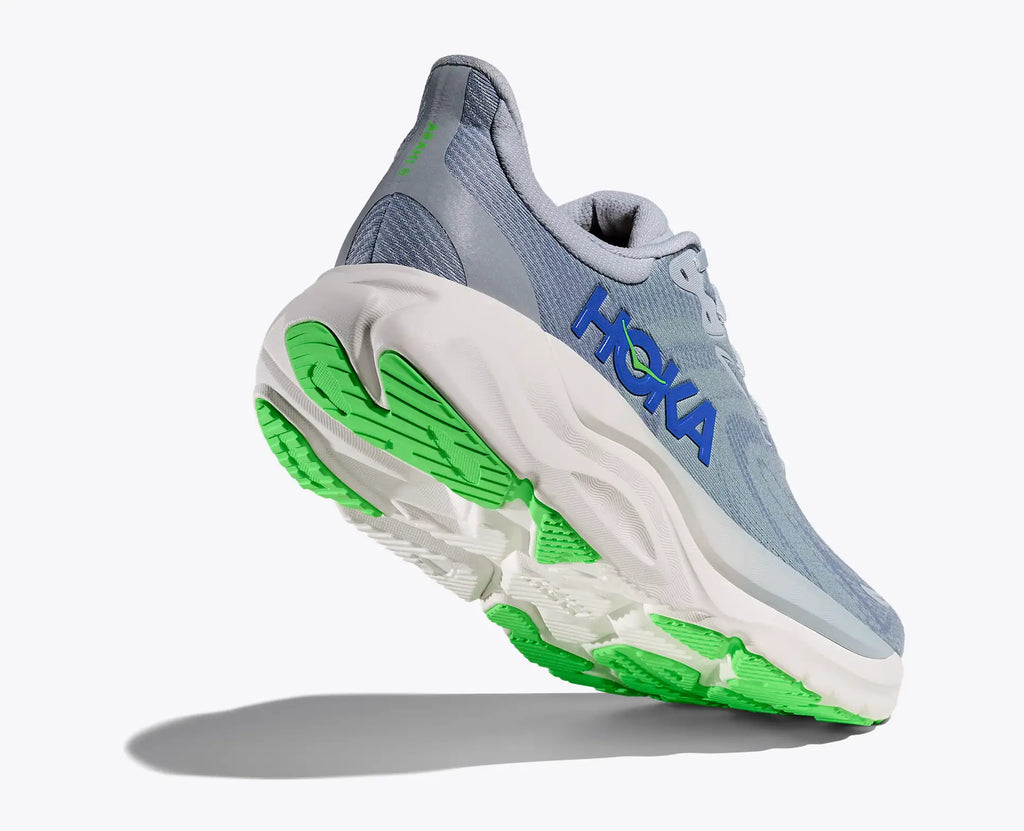 Hoka running shoe with green sole on a white background
