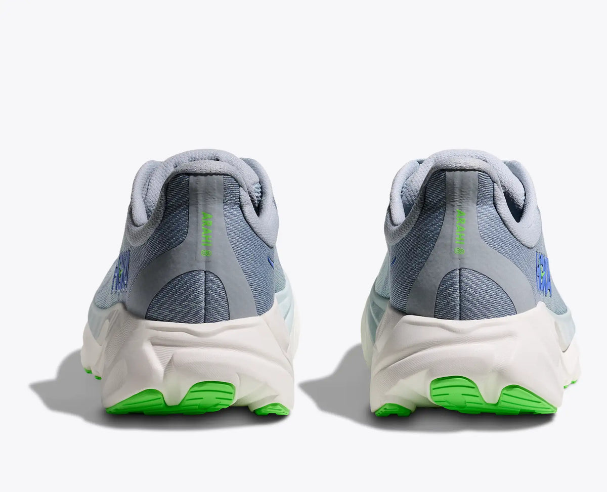 Pair of gray and green running shoes on a white background