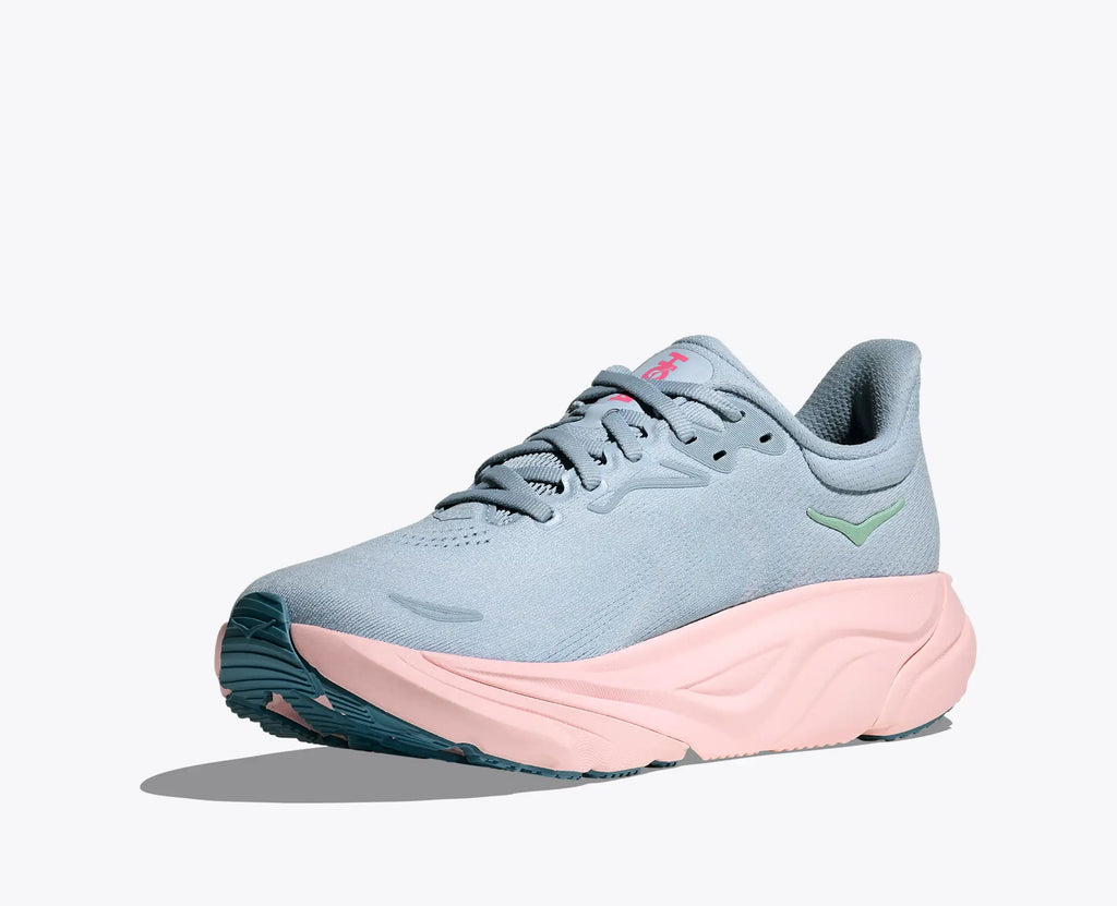 Light blue and pink running shoe on a white background