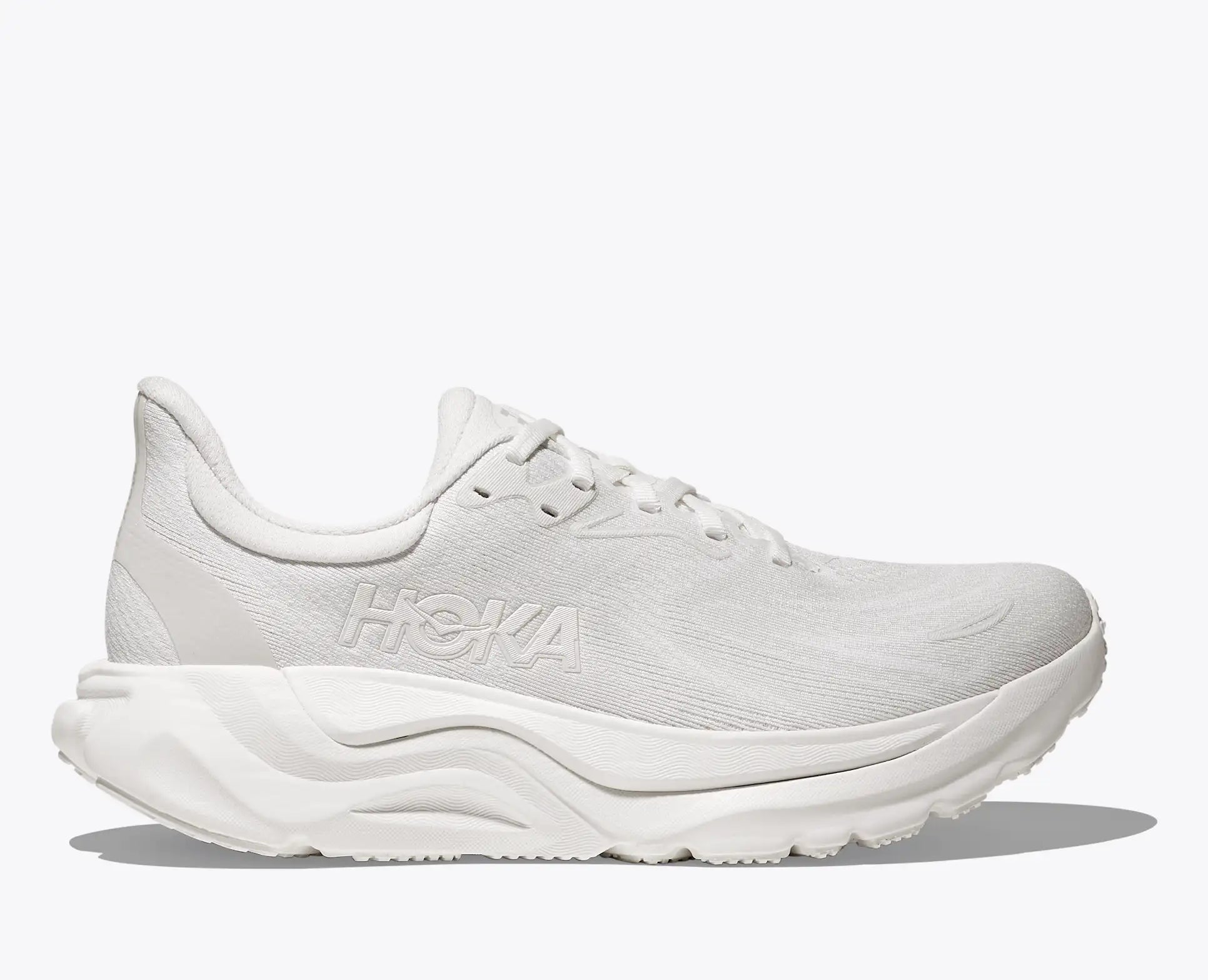 White running shoe with brand logo on a light gray background