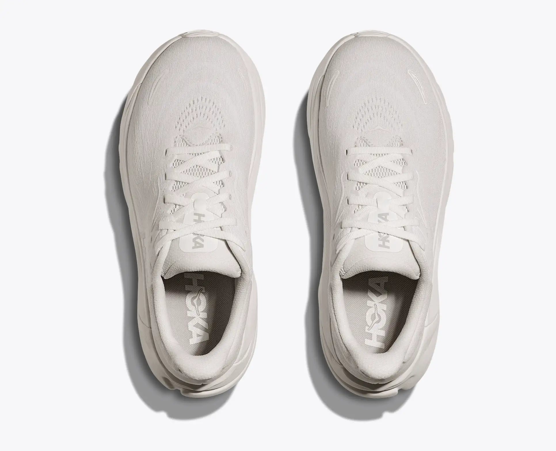 Pair of white sneakers on a light gray background