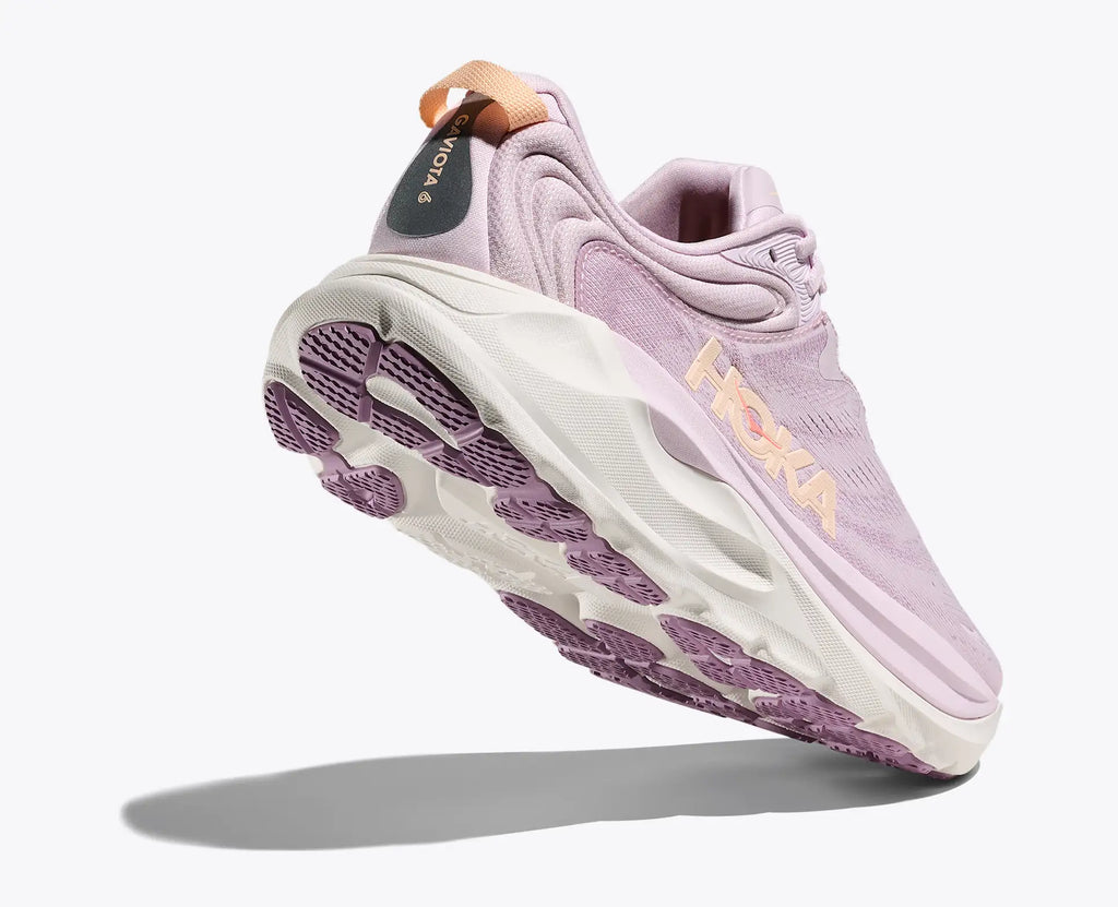 Purple running shoe with white sole on a white background