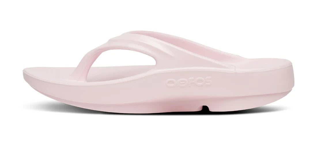 A light pink FitFlop flip-flop sandal shown from a side profile view against a white background.