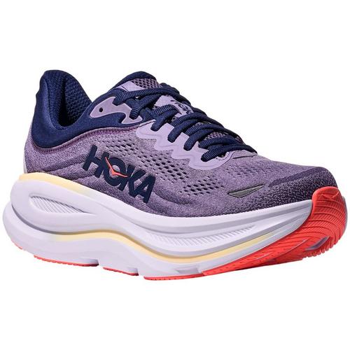 Purple running shoe with red sole on a white background