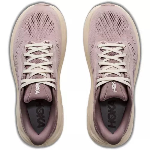 Pair of pink running shoes with white laces on a white background
