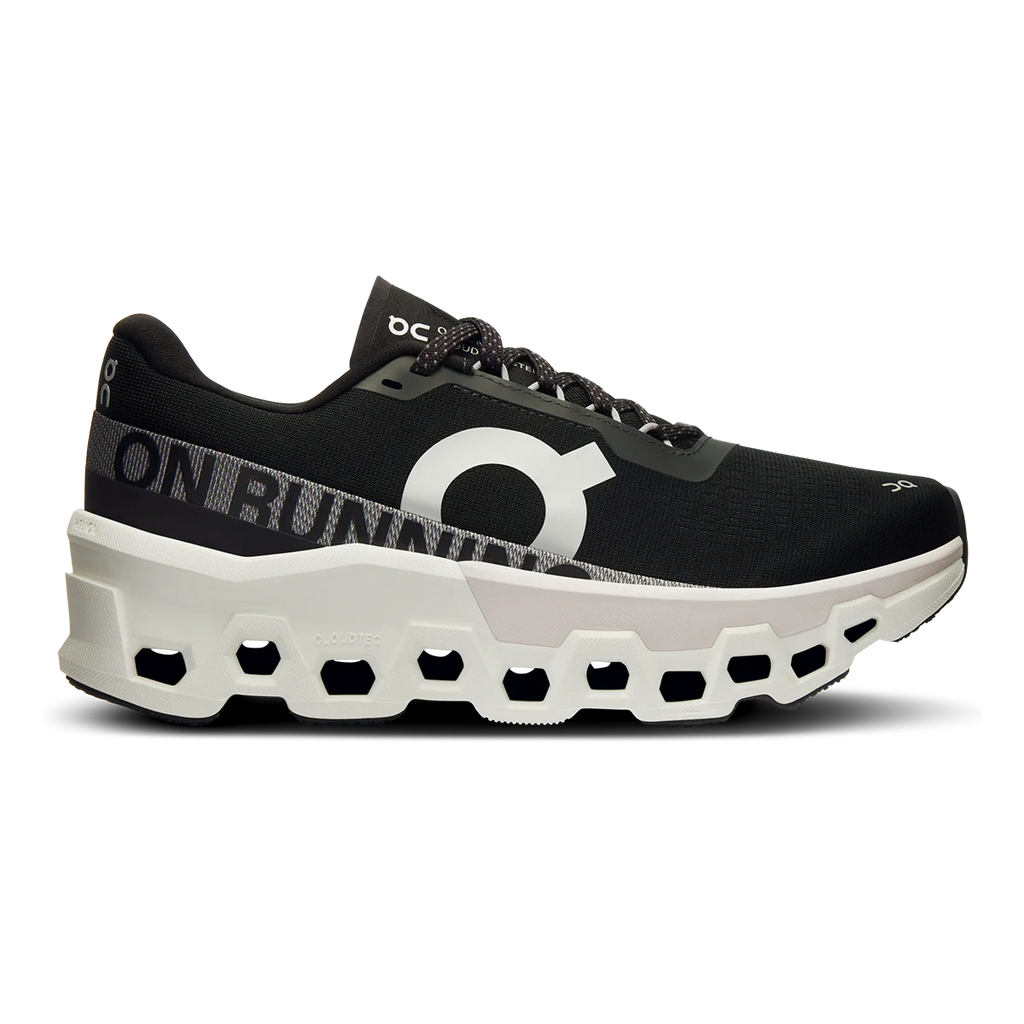 A pair of women's running shoes with a prominent black and white color scheme, featuring the CloudTec technology sole.