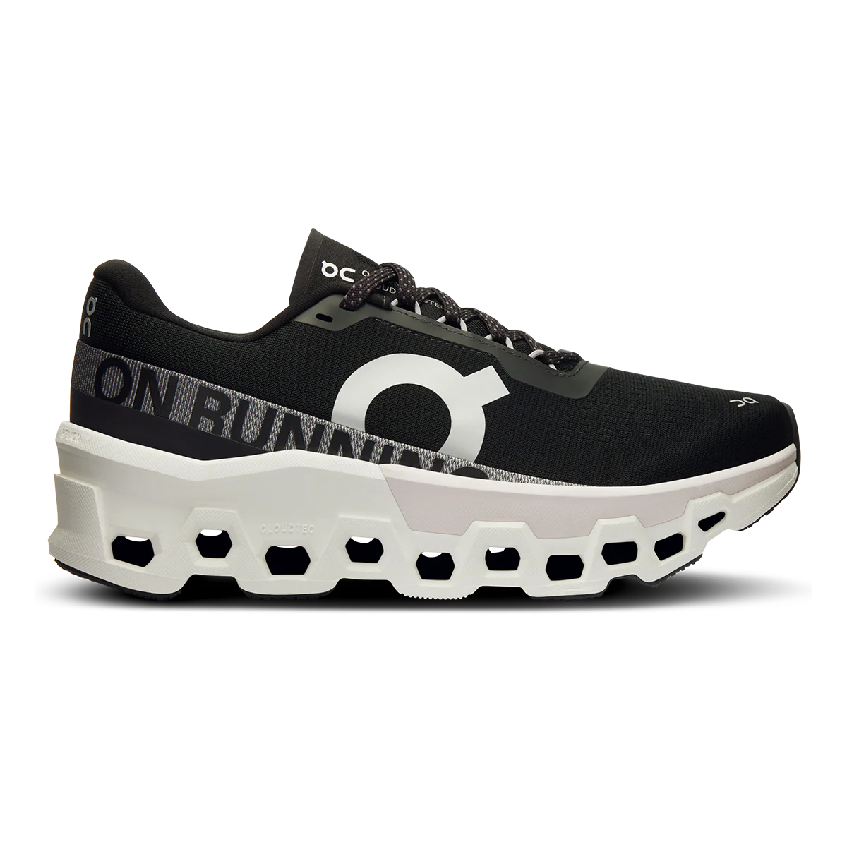A pair of women's running shoes with a prominent black and white color scheme, featuring the CloudTec technology sole.