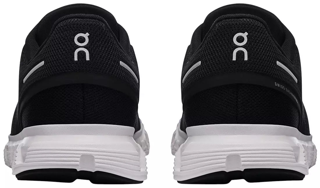 Black and white running shoes shown from the rear, featuring the white 'on' logo on the heel and a thick white cushioned sole.