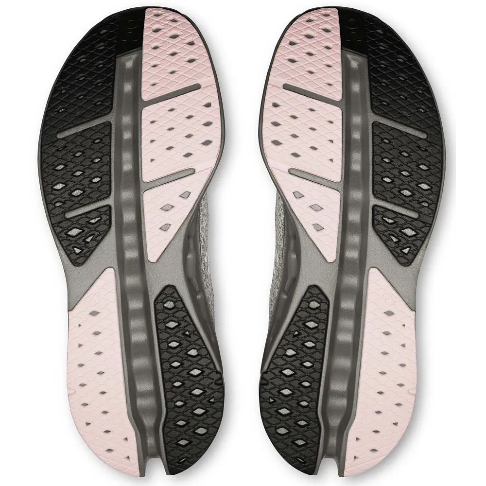 Close-up of a pair of shoe insoles with a black, pink, and gray design on a white background.