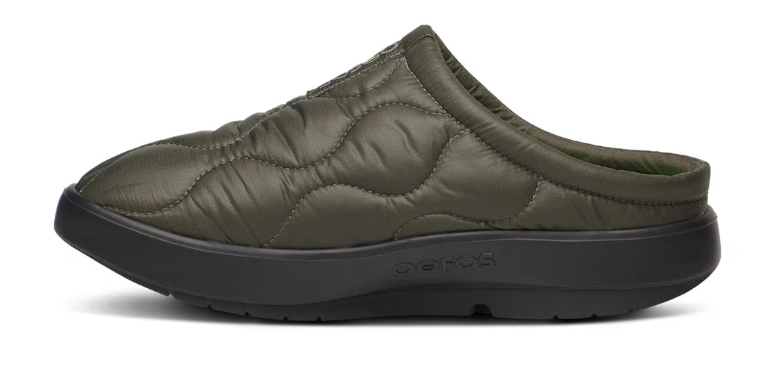 An olive green quilted slip-on clog shoe with a black sole, shown from a side profile view on a white background.