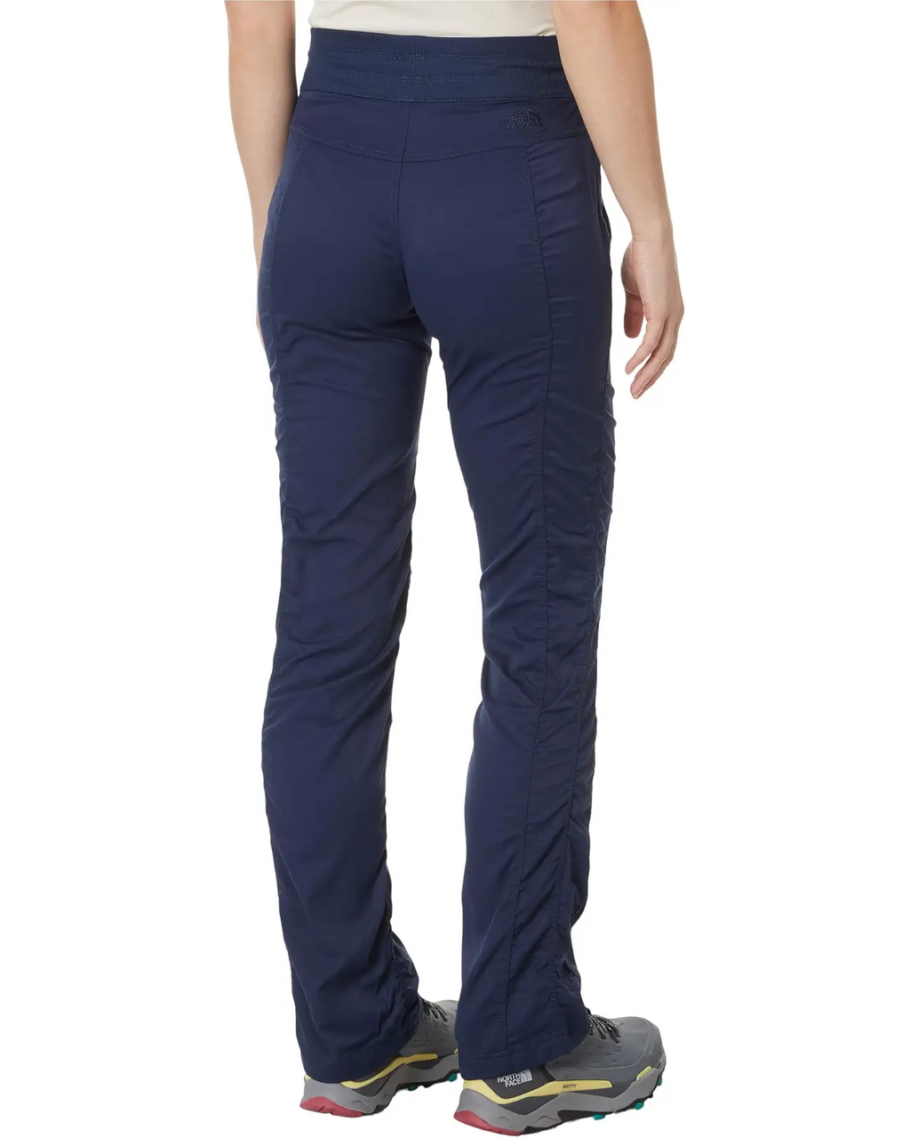 Navy blue pants worn by a person on a white background