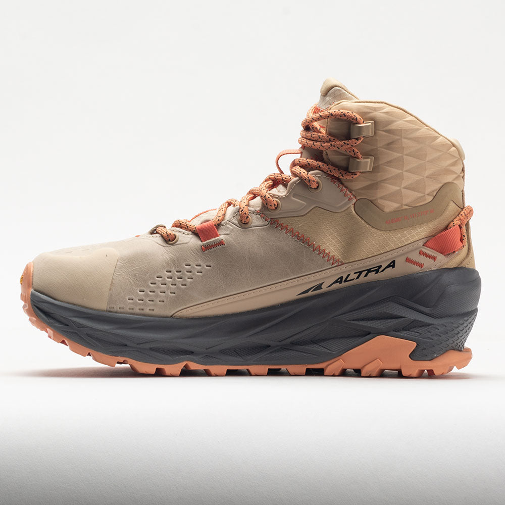 Beige hiking boot with orange accents on a white background