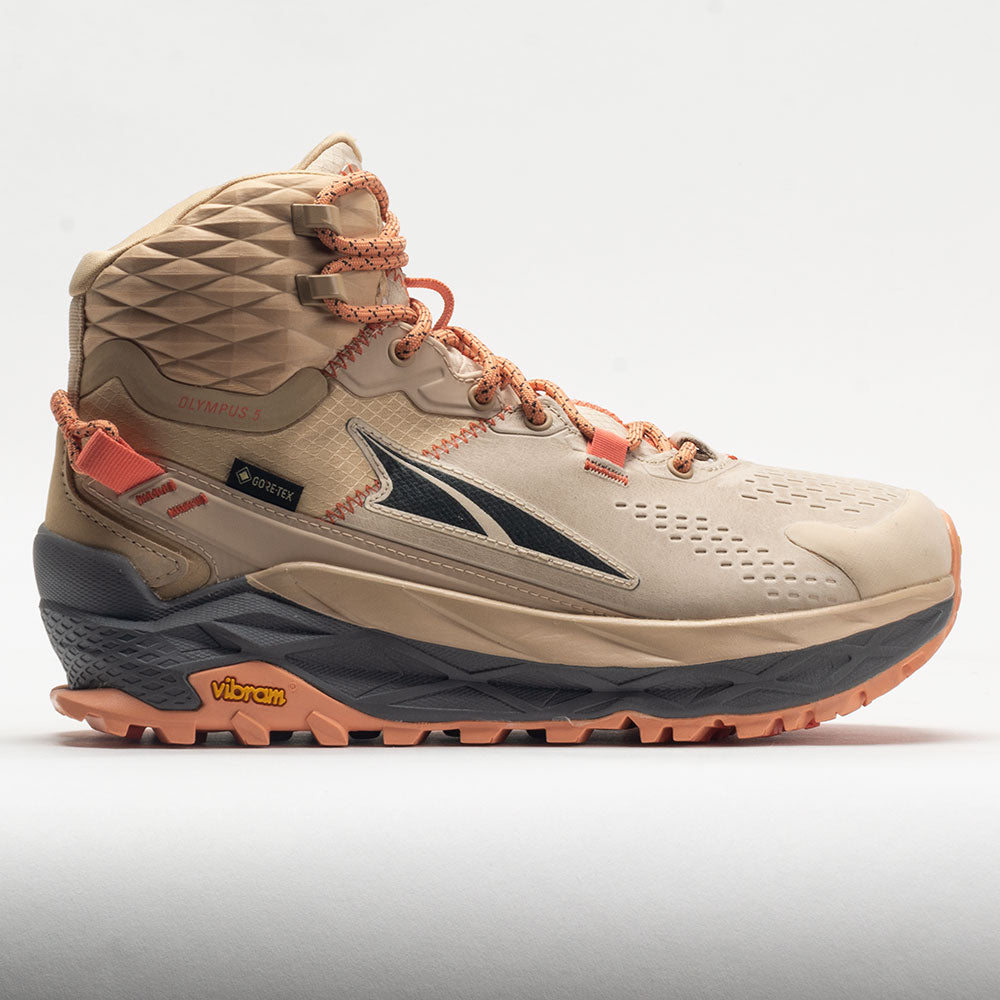 Beige hiking boot with orange accents on a light gray background