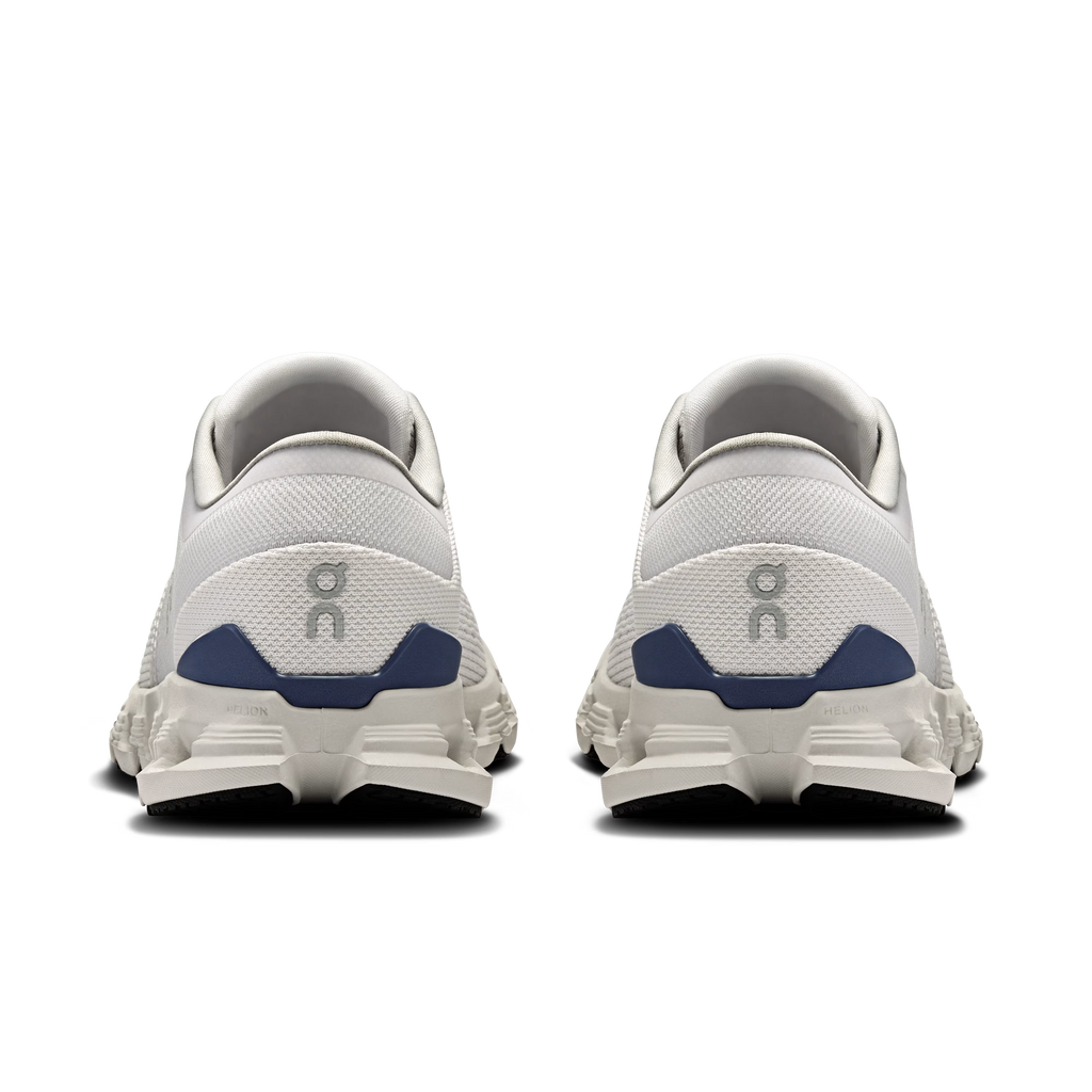 White running shoes with blue accents on a white background