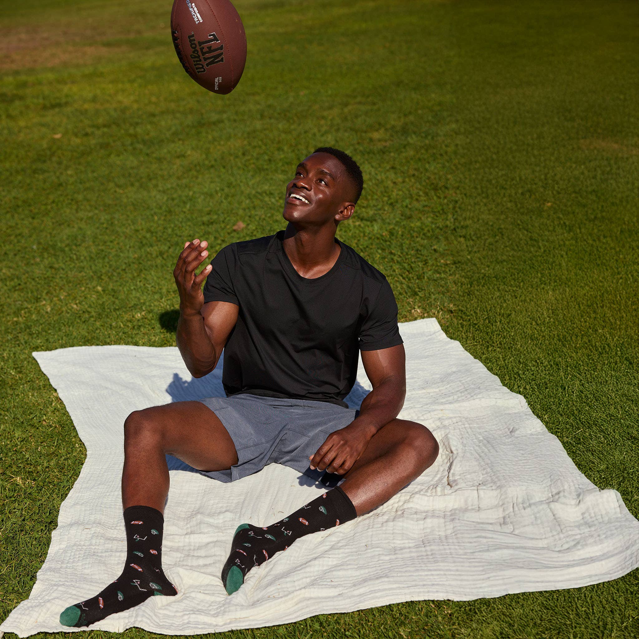 Socks that Support Youth Sports (Black Footballs)