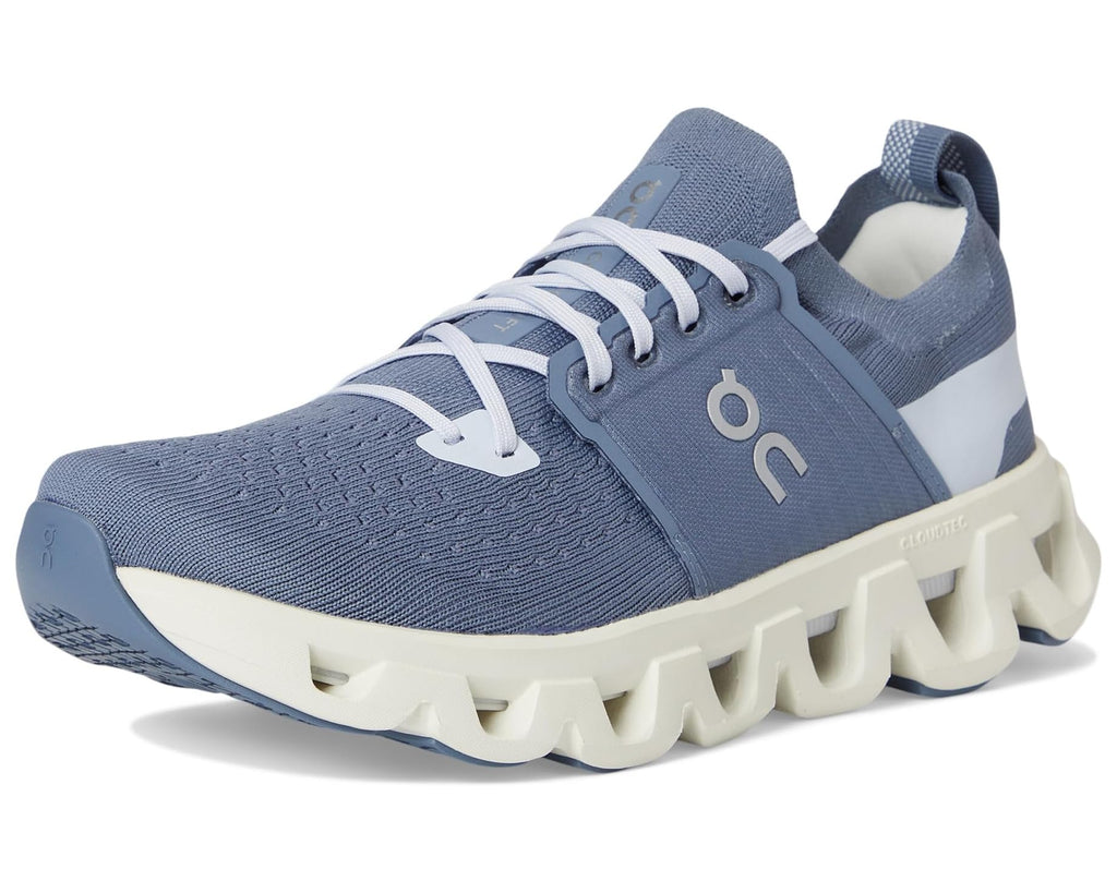 Blue running shoe with white sole on a white background