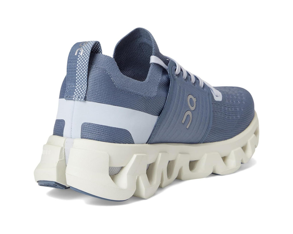 Blue running shoe with white sole on a white background