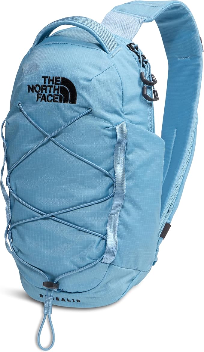 A light blue The North Face Boreal backpack with crisscross lacing on the front, black logo branding, and a white background.